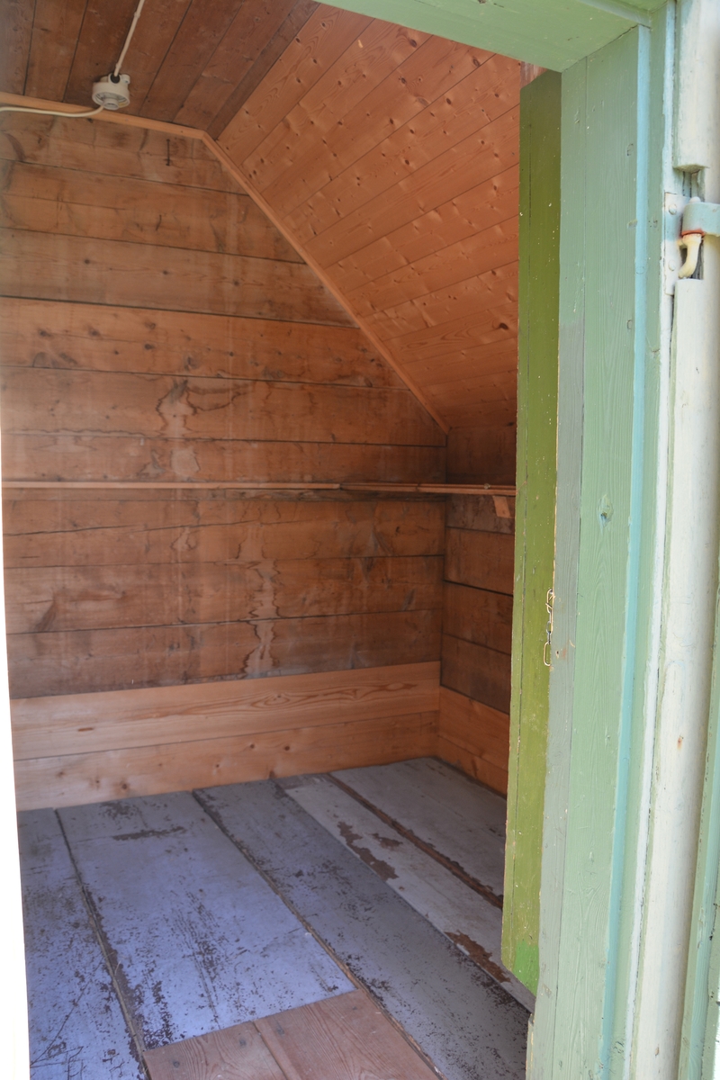 Bygning i eit rom, reisverk. Liggande panel. Dør i gavlveggen. Vindauge over døra. Panel måla mintgrøn (som bygningane i Singerheimen, Olden)