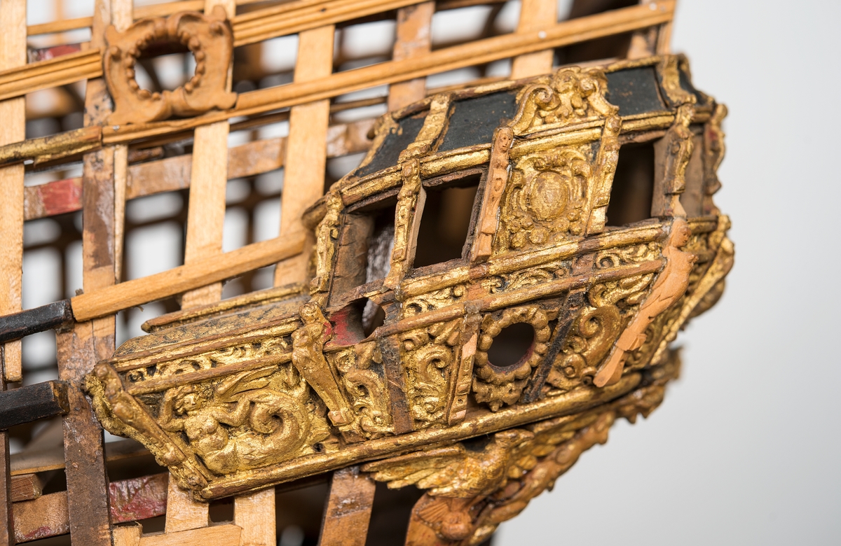 This unplanked model of a three-decker can be dated to c. 1660 and is one of the world's oldest models of a warship. Although not definitively identified, recent research links it to the Swedish ship *Riksäpplet*, designed by the English master shipwright Francis Sheldon and launched in 1661.     
The model was possibly made for Sheldon, who came to Sweden in 1659. He was one of a number of English shipwrights employed by the Swedish crown during the period. Previously, most Swedish warships had been built in the Dutch style.

From around 1660, the English Royal Navy’s administrators commissioned models that were accurately detailed and true to scale. These miniatures, which came to be called Navy or Admiralty Board models, had an unplanked lower hull to emphasise the shape of the underwater body. 

The model was restored by rear-admiral Jacob Hägg in the late 1890s. Missing parts have been reconstructed using lighter coloured wood.

3D model produced by Adam de Kaminski and Vasilis Haroupas for SMTM, 2023
