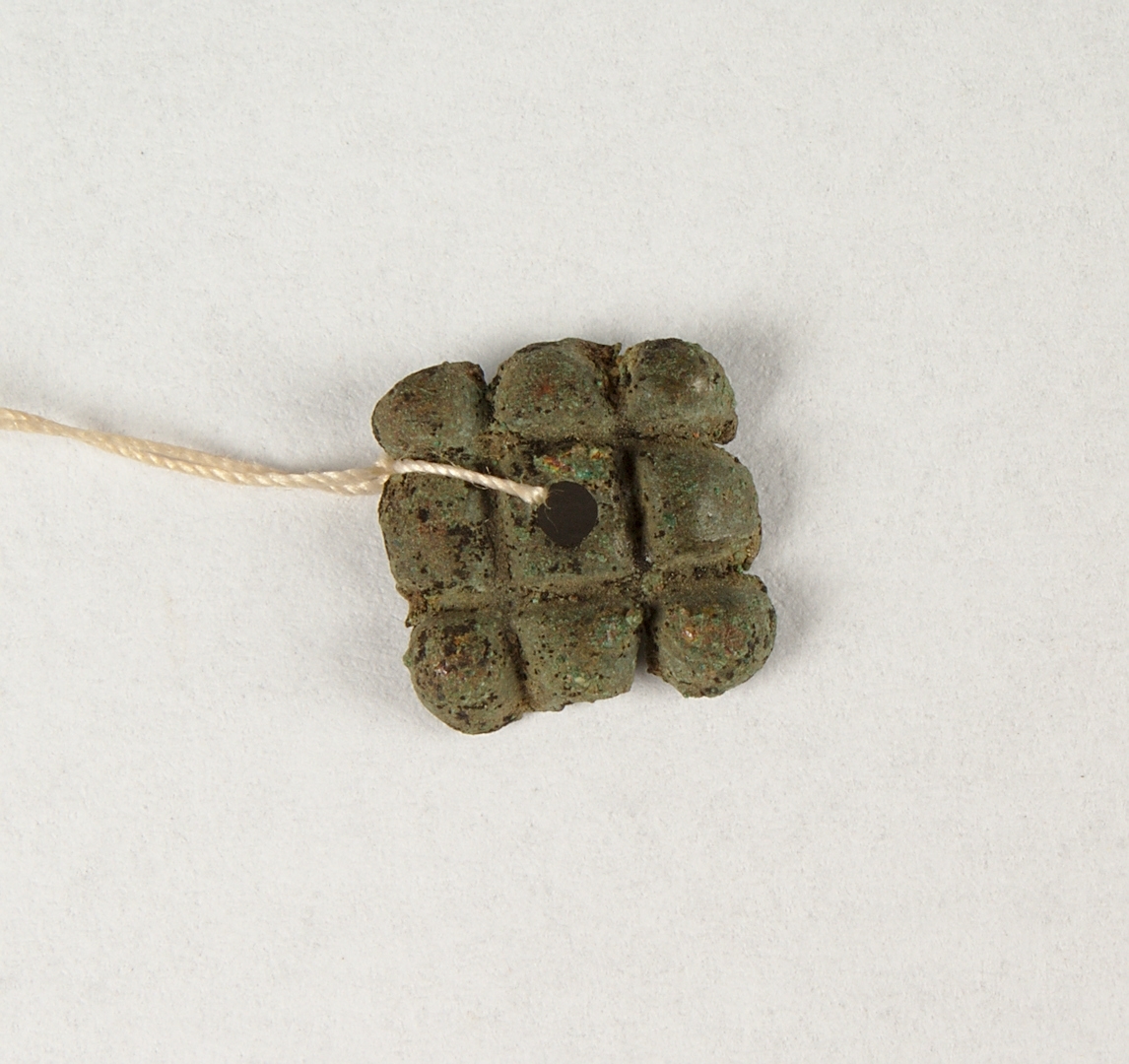 Fyrkantigt ornerat beslag.