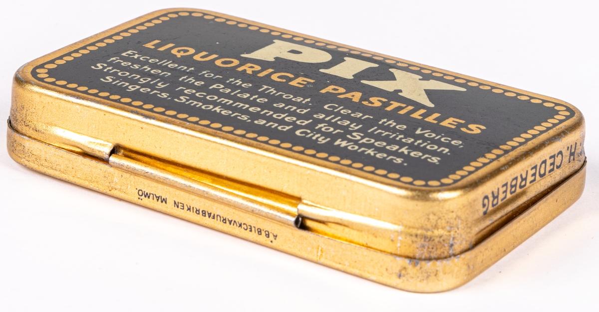 Tablettask i plåt, guldfärgad och blå botten med vit och guldfärgad text:" PIX PASTILLES PIX COMPANY LTD. GEFLE. SWEDEN".