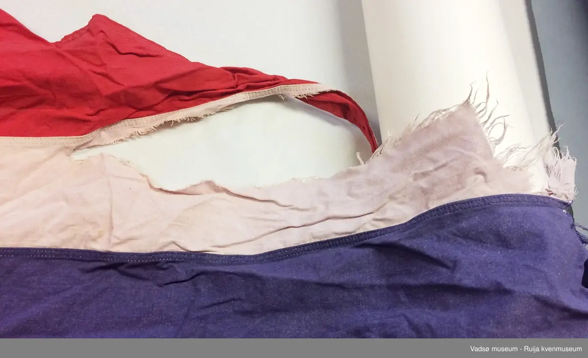 Stort vimpelflagg. Flagget har slitasje på enden.