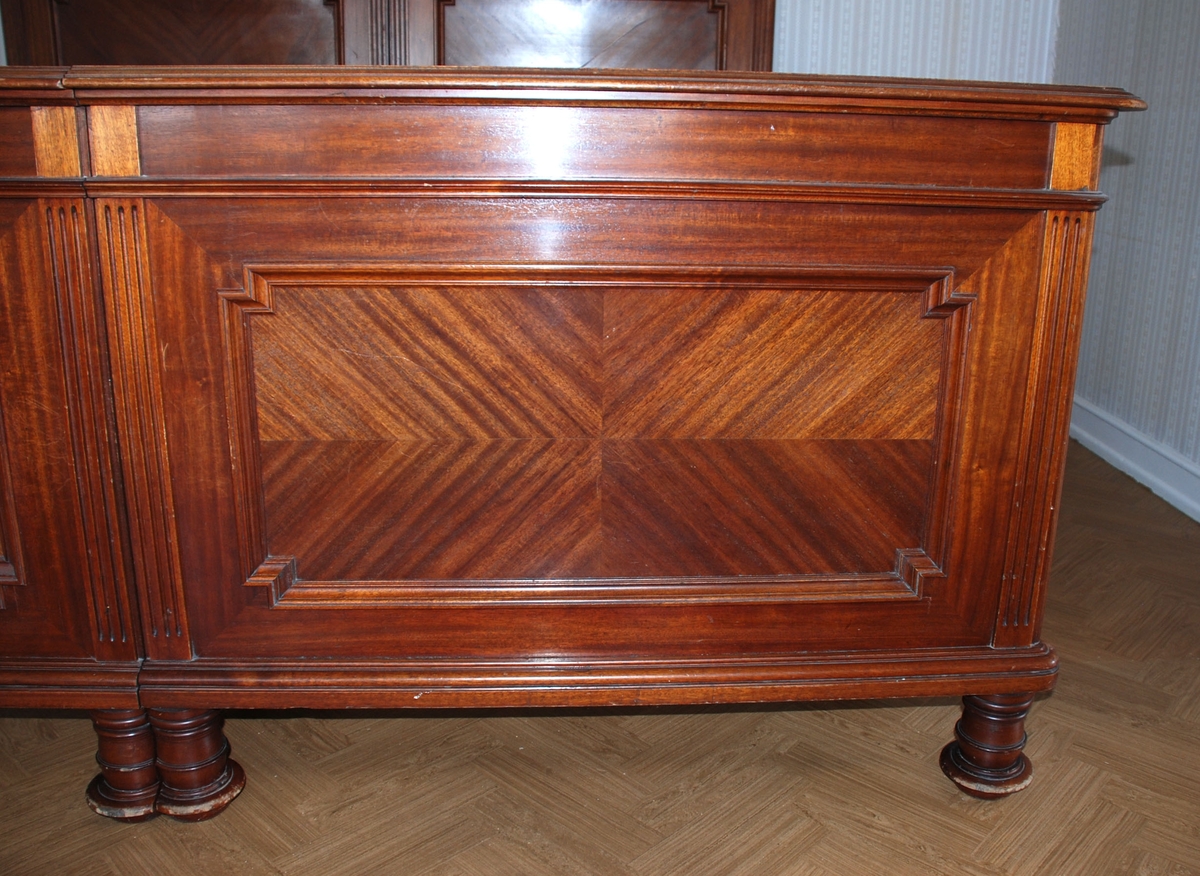 Dobbelseng som består av to enkeltsenger som står inntil hverandre. Mørkbeiset brun seng i heltre og finèr.