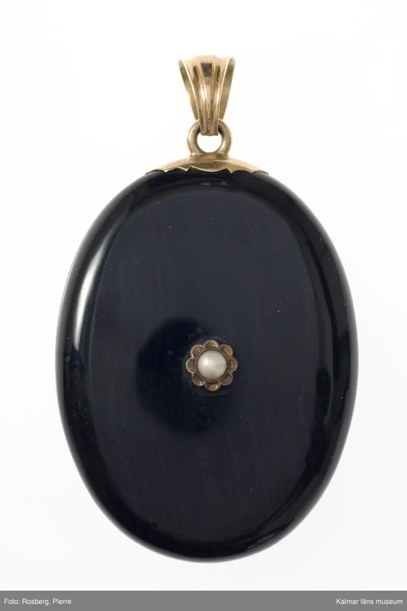 KLM 34780:2 Medaljong av svart material med inläggningar av silver, infattningar av gul metall och pärlor. Förvaras i oval röd ask med text: A Michelsen, Hof og Ordens- Juveler, Kongens Nytorv.