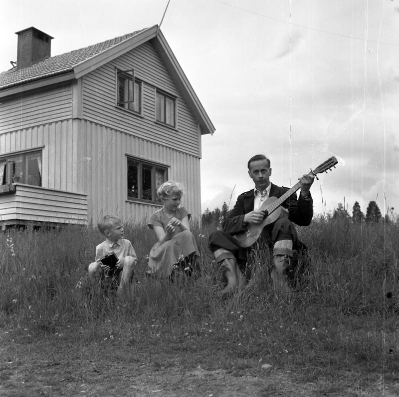 Fotografi av Vidar Sanbeck og to barn utenfor et hus.