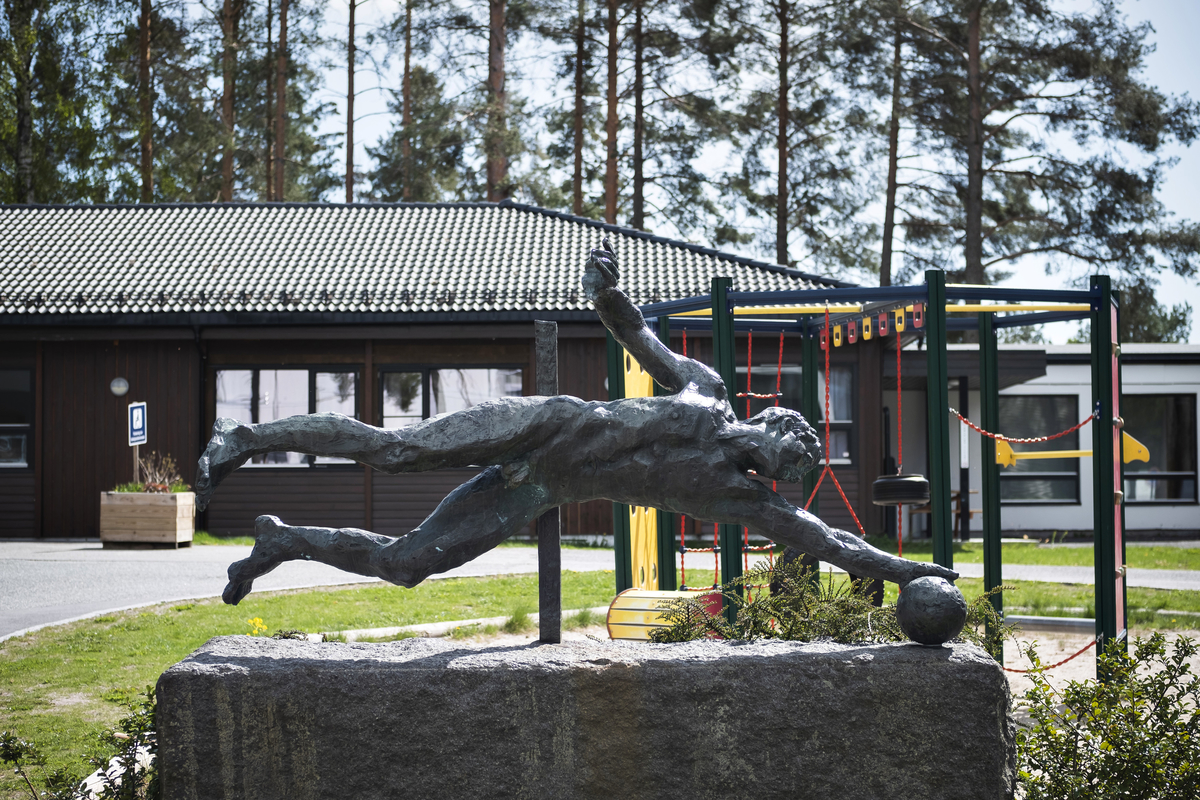 Mannfigur som slenger seg etter ball.