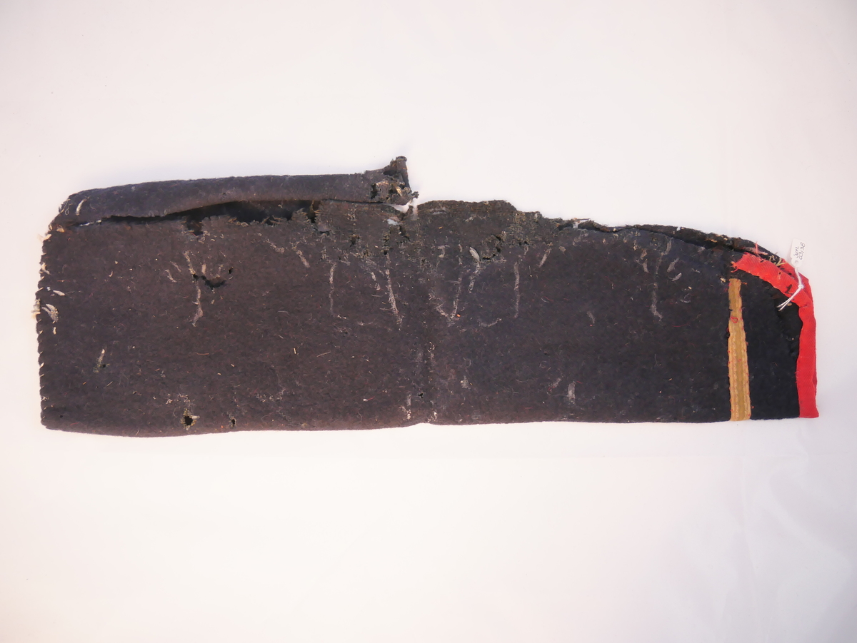 Erme til opplut eler trøye. Påsydd mansjett framme, horrlandsborde i grønfargar sydd over skøyten, mansjetten kanta med raudt band.