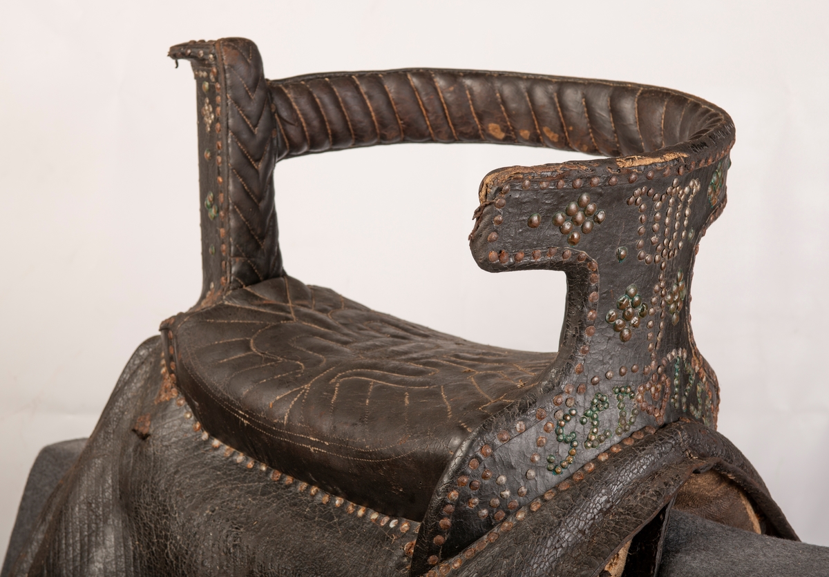 Lær på hele sadelen. Setet syd mønster. Nagler av jern og kobber. Initialene i kobberstift: SLD og årstallet 1755.