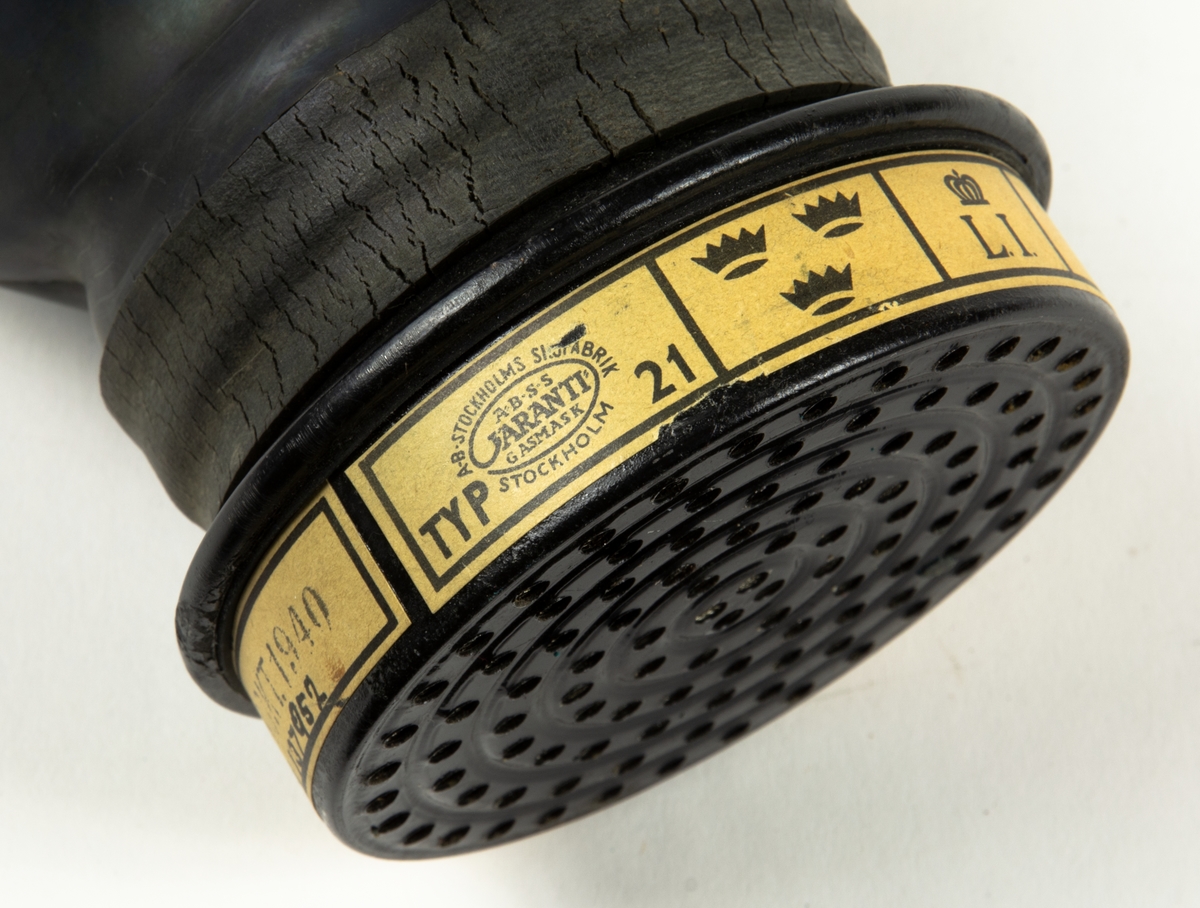 1. Gasmask med tygväska. Innehåller även instruktionsbok..
2. Gasmask av gummi med filter Typ 21.
3. Filter till gasmask, koloxidfilter M2311-721.