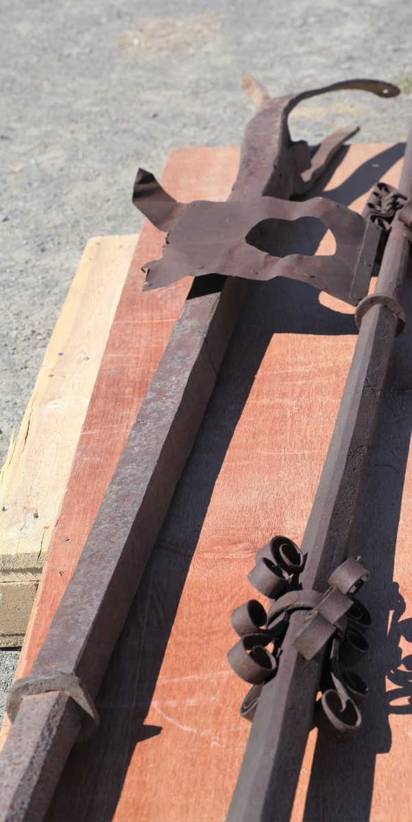 Nederste del av spiret til Aas kirke. Jernstang med tre kjør i den ene enden.