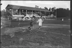 Fotboll. Match på  på Tranebergs IP, publik på läktaren. D.I.F. står skrivet på läktarens gavel.