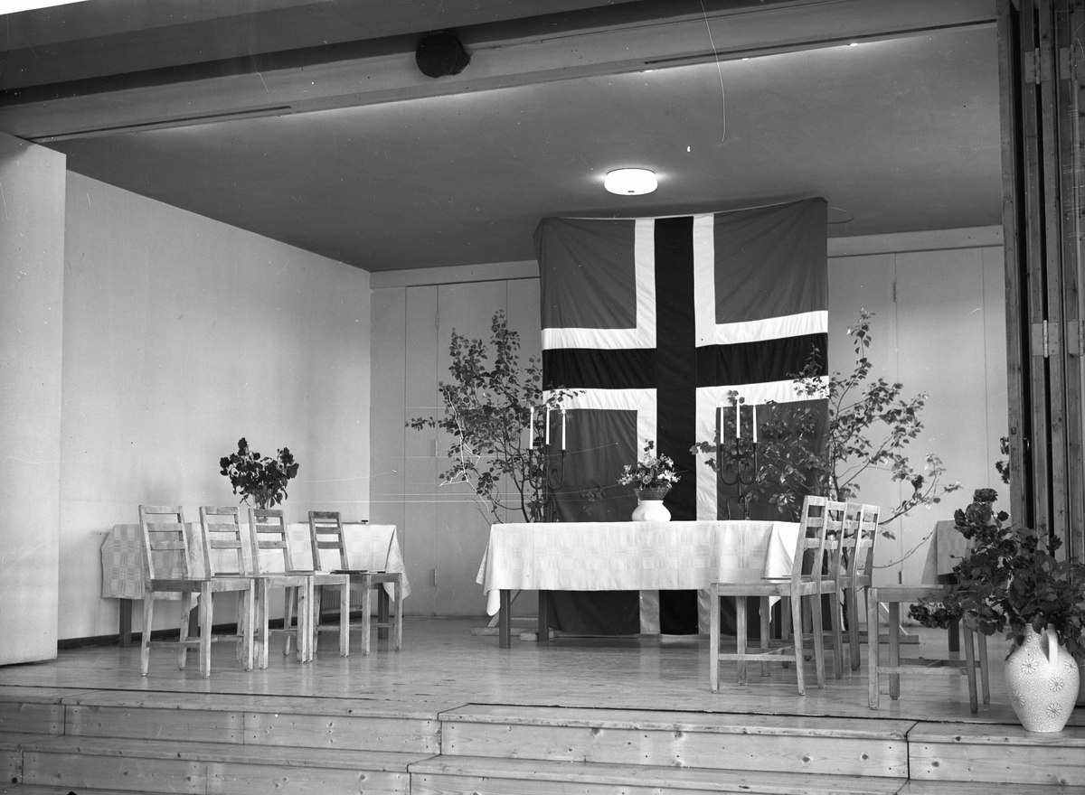 Prest foran flagg.