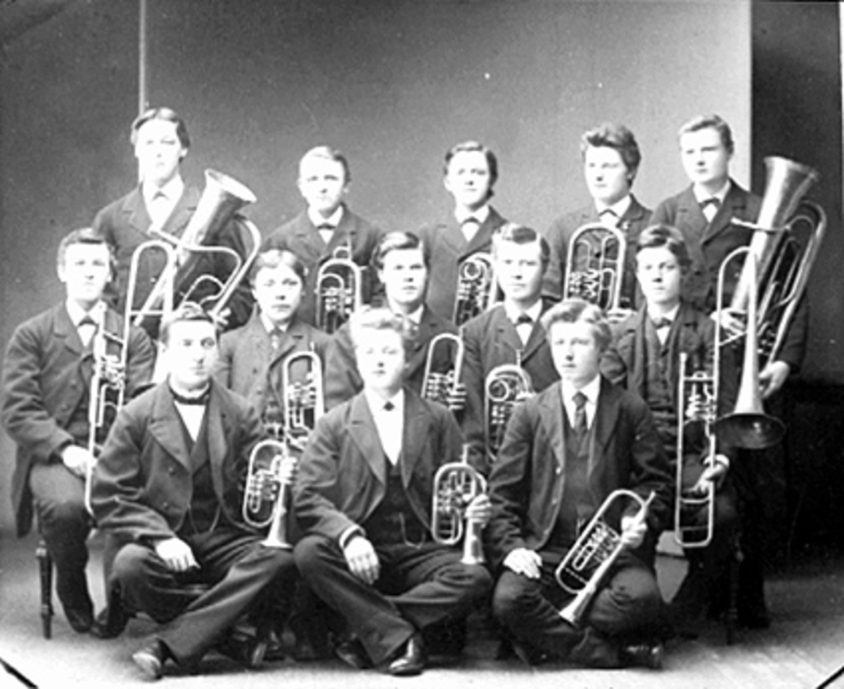 Hamar, gruppe 13 musikere med instrumenter, Hamar Musikkforening, Instruktør Hagbart Hollo, 1 rad venstre: Hagbart Hollo, Arne Bakke, Andr. Minken, , 2 rad venstre: E. Halseth, Nils Jensen, H. Thovesen, J. Skaråsen, Aug. Andersen, 3 rad venstre: Ludvig Sannerud, H. Haugen, Knut Aas, Knut, Ole Thoresen, Børresen, blåseinstrumenter,
