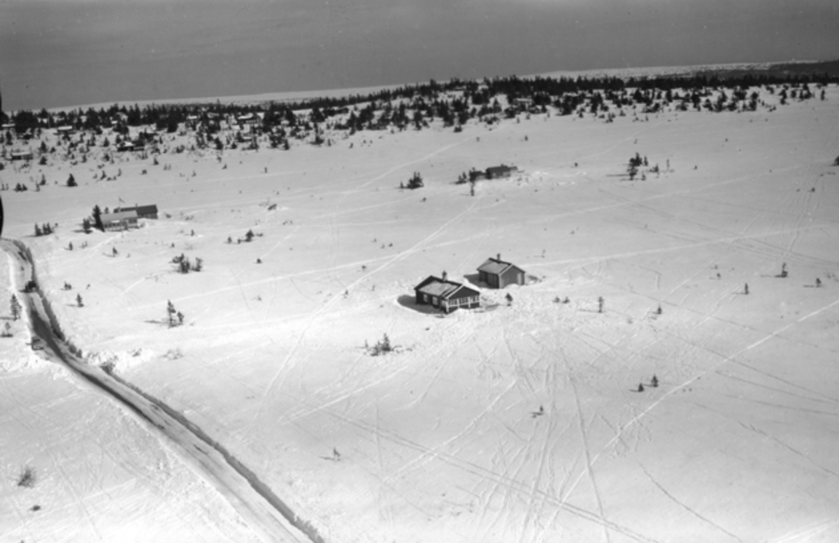 Flyfoto av bebyggelse i vinterlandskap på Ljøsheim, Ringsaker Almenning.