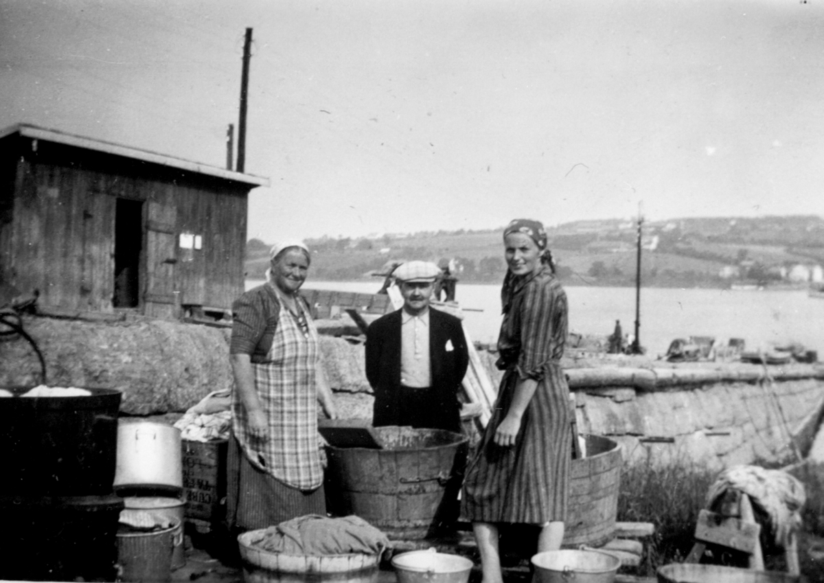 Klesvask ved Sundsbrygga, Helgøya. Fra venstre er Helga Sund (1891-1962), Adolf Solheim f.1877, Karen Røste (Sund) f.1917.