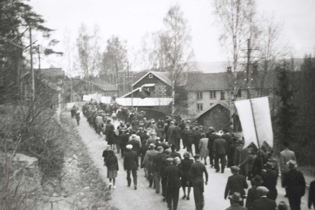 Ringsaker, Moelv, Storgata, 1. mai tog1946-47 ved Dehli butikken, til høyre Mokvern gård med drengestubygningen hvor det hadde vært bakeri,