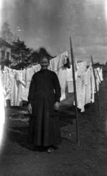 Ukjent kvinne henger opp klesvask til tørk.