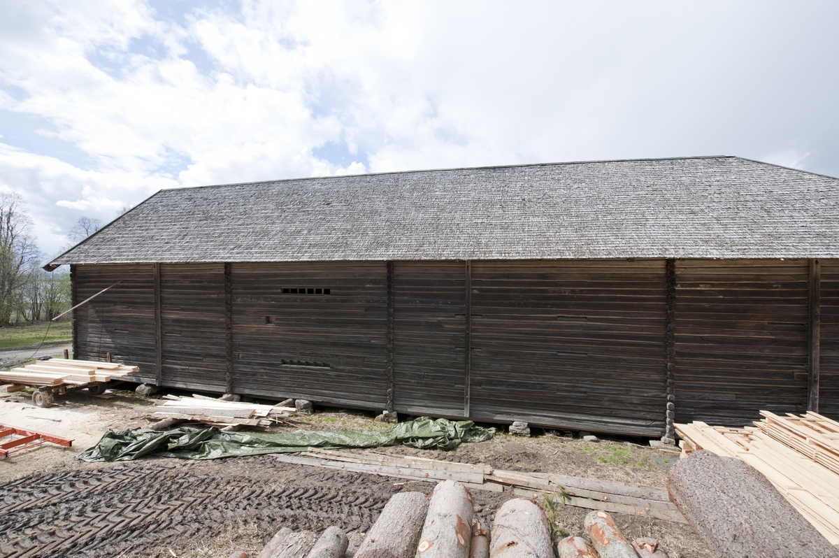 Låve med to fløyer i vinkel, laftet: Bygningen har saltak tekket med flis. Kjøringa går gjennom hele bygningen og har sin begynnelse over stallen i nord. Dette er et tidlig eksempel på en enhetslåve der mange funksjoner er samlet under et tak. Stallen har innredning for fem hester med krybbe og foringsgang. På langsiden inn mot tunet er det oppført et hus for hestevandring. Det har pyramideformet tak som hviler på stolper.