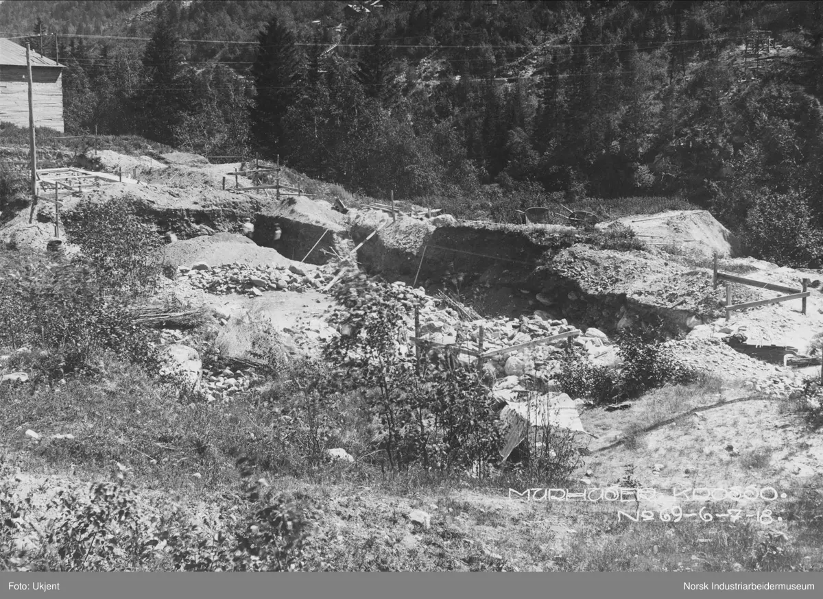 Murhusbebyggelsen på Krosso under oppføring. Utgravning til grunnmur er i gang. Vemorksporet i bakgrunnen.