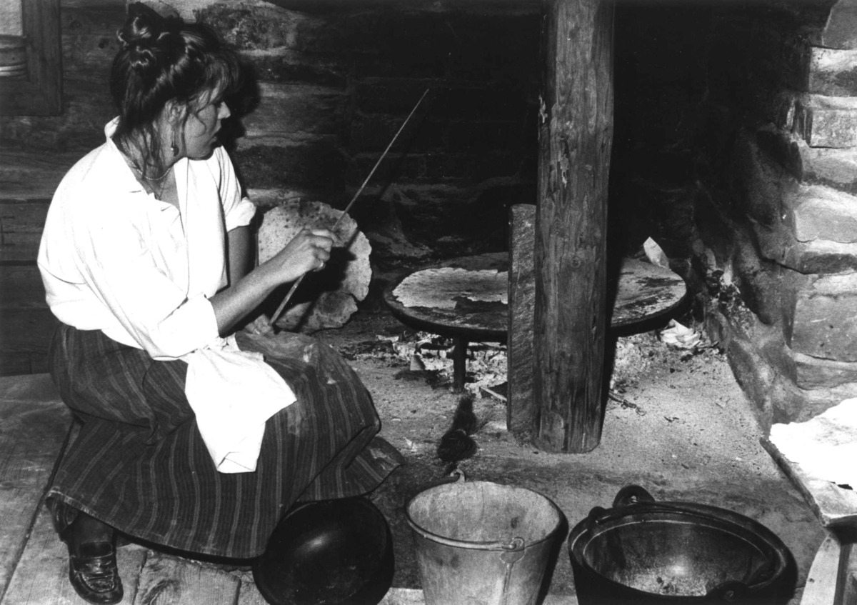 Flatbrødsteking v/ Cathrine Aspelund i eldhuset i Numedalstunet, 1986.