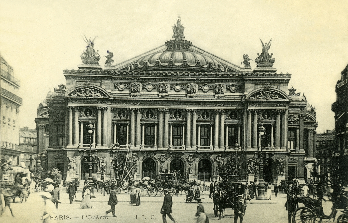 Postkort. Jule- og nyttårshilsen. Fotografisk motiv. Svart/hvitt. Motiv fra Paris: Operaen. På plassen i forgrunnen fotgjengere og hestekjøretøyer. Stemplet 17.12.1908?