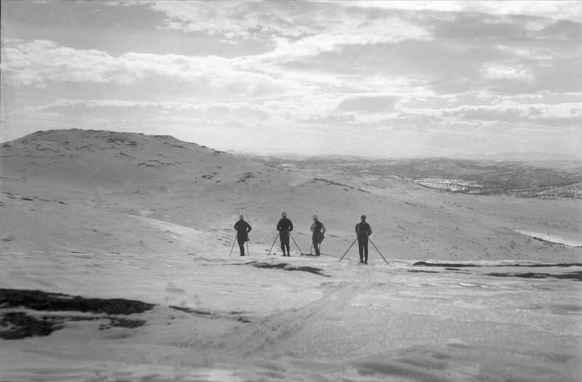 Fire menn på ski over Burrefjell. Fotografert Påsken 1922.