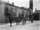 Brandkåren. Brandkåren rycker ut i början av 1900-talet. På kuskbocken sitter brandmästaren J. Svensson och polis J. Fält. På stegvagnen syns brandmännen/poliserna Per Dahl, F.W. Nilsson och E. Olovsson.