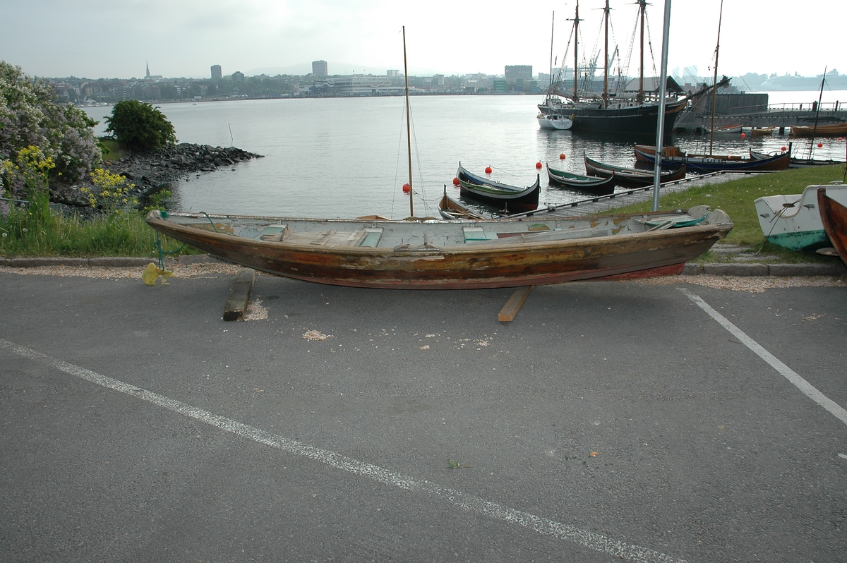 Prammen har tre tofter, fiskekum, plikt forut og akter, 4 bordganger på hver side,   utvendig bunnbord, sekundært feste for påhengsmotor på akterspeilet og tollegang for ett årepar. Ett par årer hører med. De er grå- og grønnmalte.  L=244cm. Innkommet sammen med NSM.11404 ( ruse ).