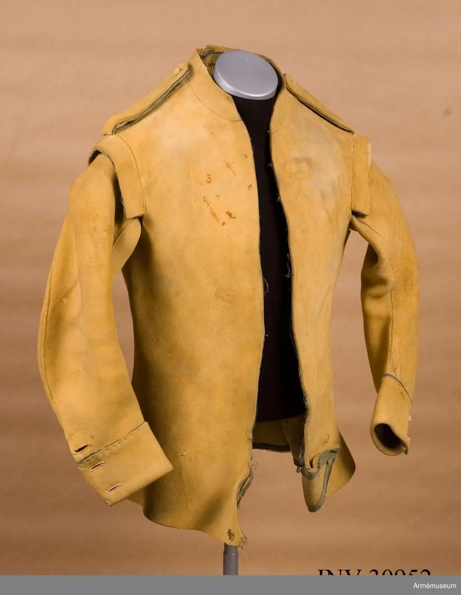 Kyller av gul älghud med blå linneband som kantning på insidan. Lätt utsvängt nertill med litet skört bak. Uppvik framtill, axelkarmar och låg krage.  Kragens linneband är i dag i upplösning och bara några trådar finns kvar.
Helt framtycke, och delat bakstycke samt två separata sidstycken. Sidsöm under ärmen.
Formade tvåsömsärmar med ärmuppslag. Ärmuppslagen har blå passpoal och sprund som knäpps med 3 koniska knappar klädda med sämskskinn i samma färg. Ett fjärde knapphål som är igensytt talar om att plagget blivit omsytt vid något tillfälle. En rad hål efter stygn på insidan av höger framstycke visar att plagget har haft en knappstolpe/underlott.
Axelklaffar fodrade med blått linne som knäpps vid kragen med samma knappar som ovan.
Plagget knäpps kant i kant mitt fram med 12 stycken hyskor och hakar av metall. Alla sömmar är sydda med oblekt lintråd.
Märkt inuti ryggen med "N 2".