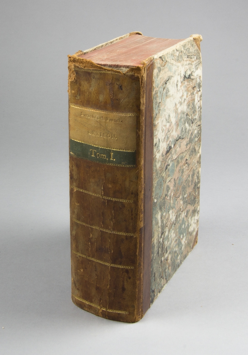 Bok, lexikon, halvfranskt band: ”Svenskt och fransyskt lexicon. Tome I. A-M.” skriven av Erik Wilhelm Weste, tryckt hos P. Sohm och utgiven av J. C. Holmberg i Stockholm 1807.

Bandet med sparsamt guldornerad rygg, grön och beige titeletikett i skinn och med röda snitt. Pärmen klädd i marmorerat papper. Med otydlig namnteckning på främre pärmens insida.