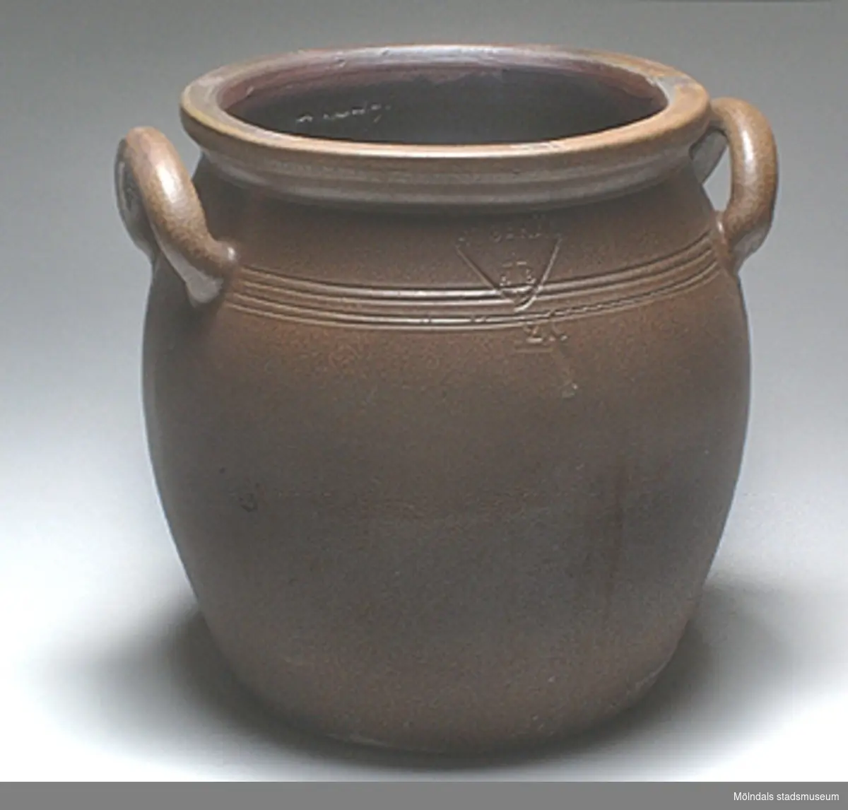 Sex stycken Höganäskrus, i mörkbrunt stengods. MM02271.
:01 Volym: 20 liter. H: 350 mm. Diam: 330 mm. 
:02 Volym: 15 liter. H: 240 mm. Diam. 330 mm.
:03 - 6 Volym: 12 liter. H: 290 mm. Diam: 290 mm.

Från Stretered centralkök. Genom Husmor Elsa Blomstrand.