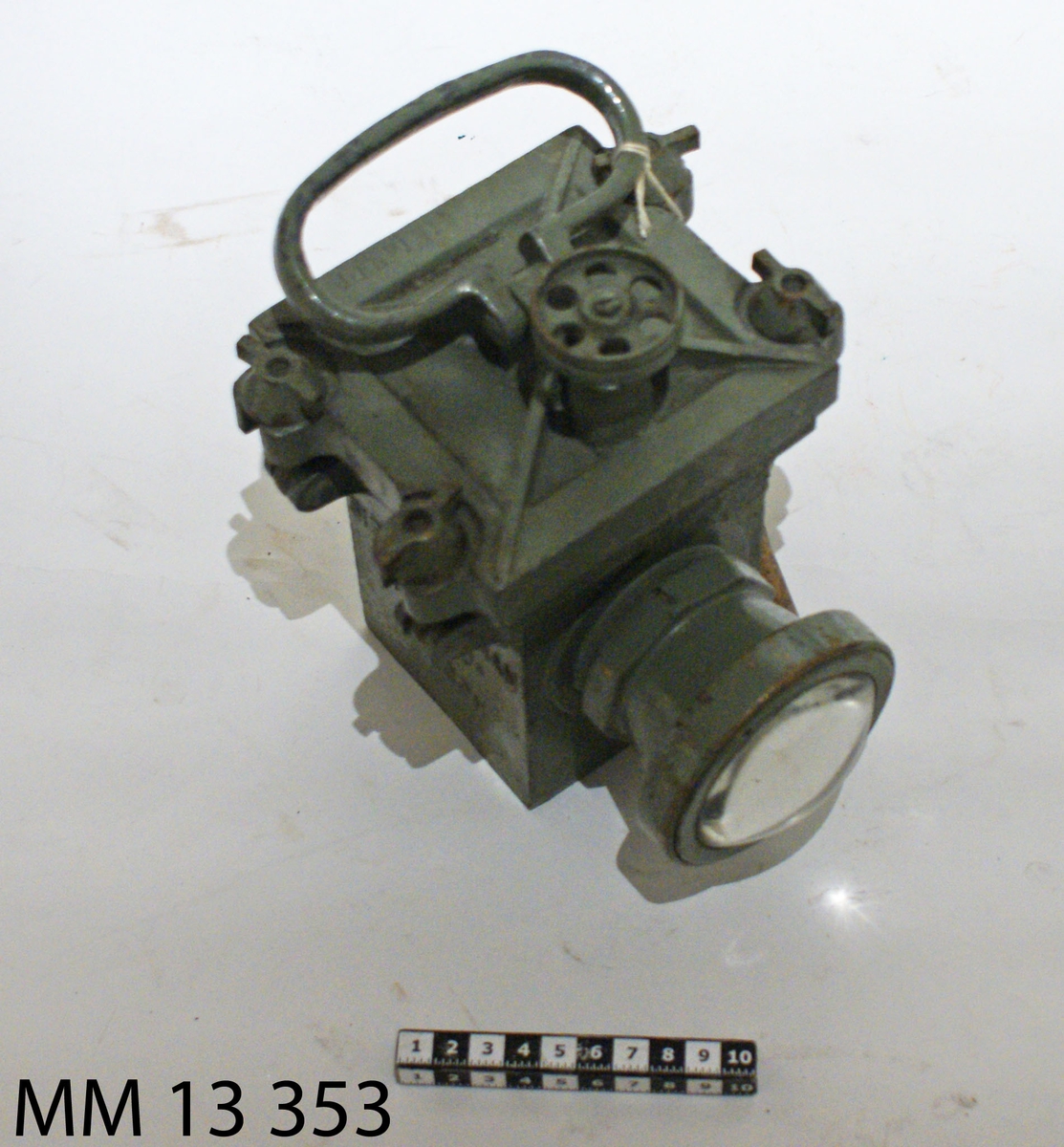 Lyktan gjuten. Cylindrisk hållare för glaset. Locket fasthålles med fyra bultlar med vingmuttrar. På översidan fällbart handtag och en kontaktskruv med ratt. Gråmålad.
Märkning: SIEBE GORMAN & CO L TD LONDON DELFINEN