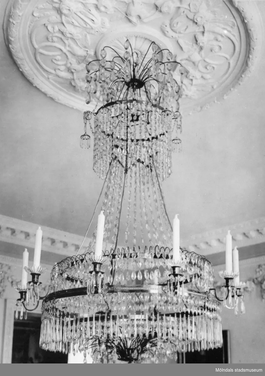 Takkrona med slipade kristallprismor och plats för ljus. Gunnebo slott, 1930-tal.