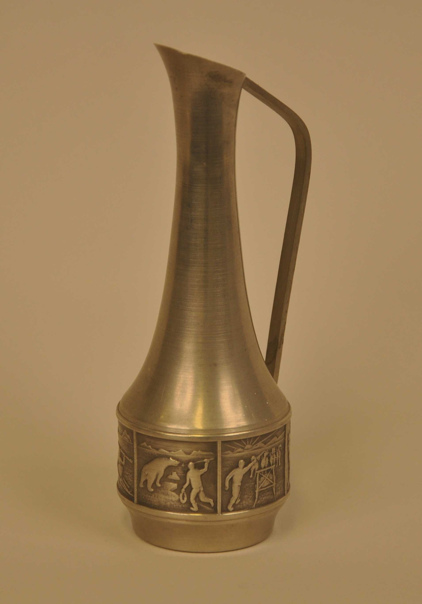 6 små bilete der 2 av dei vert gjentekne medan 2 finnast i eit eksempel. Eitt av dei syner eit par som dansar etter trekkspelmusikk, eit anna syner fangst frå kajakk med spydet klargjort til kast, det tredje syner ein isbjørn som vert jakta. Det fjerde bilete syner drift av hundespann.