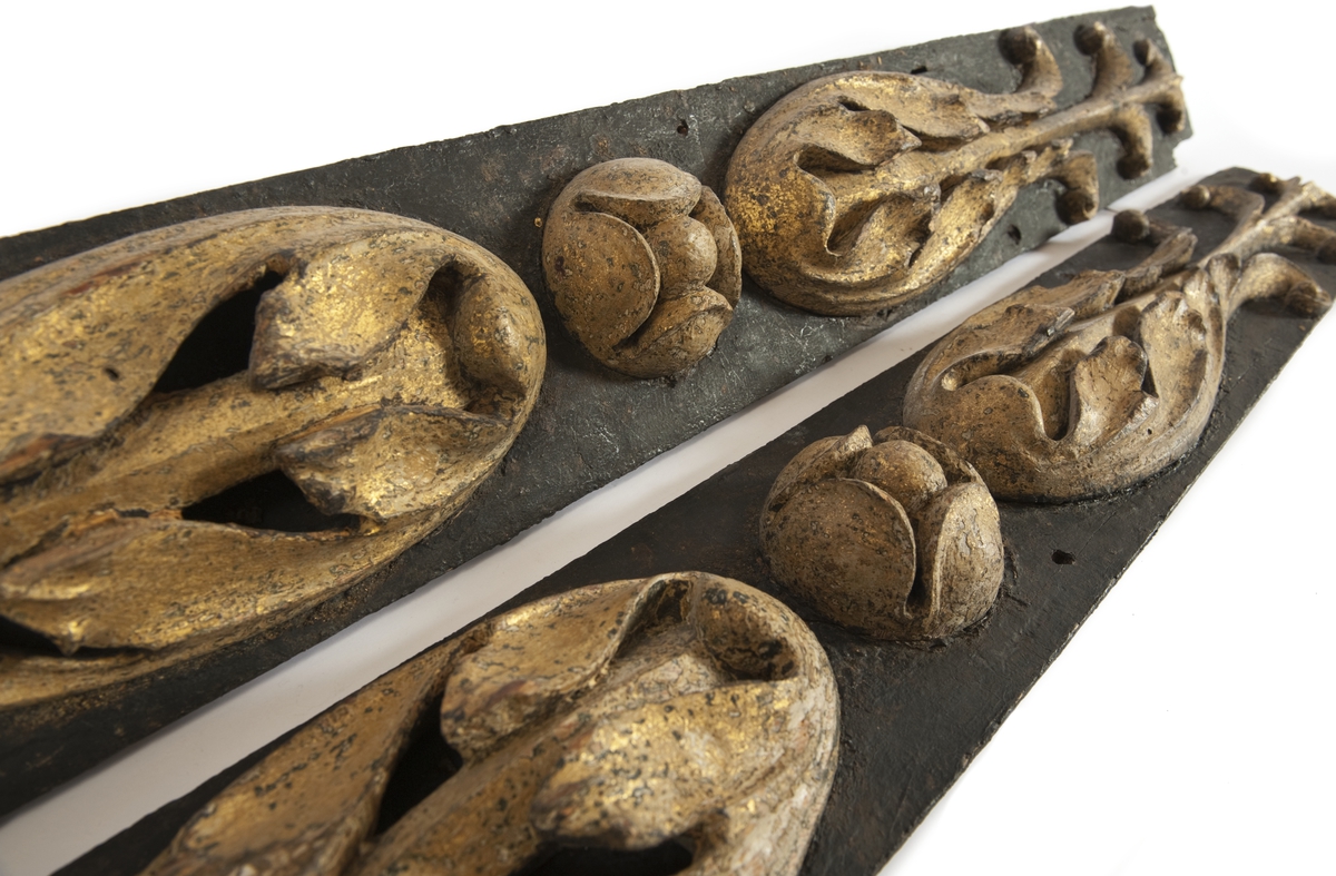 Pilaster till EUGENIES akterspegel. Skulpterade gulmålade blommor på underliggande förgyllning, monterade på plan av svartmålat trä.