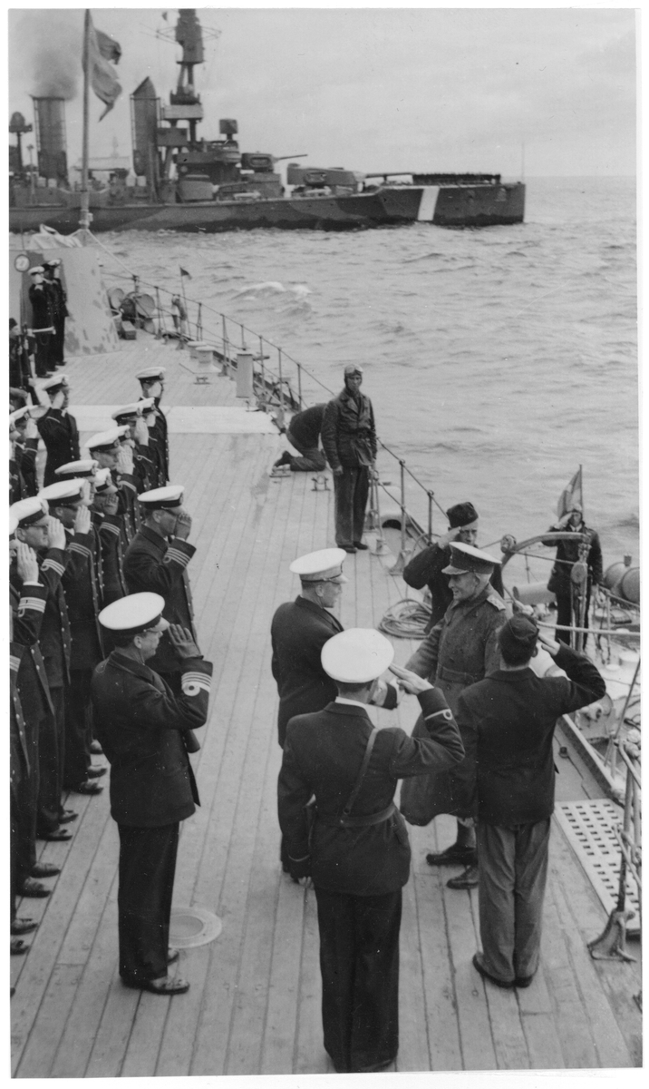 Marinchefen viceamiral Tamm med flera marinofficerare hälsar överbefälhavaren general Thörnell på pansarskeppet Sveriges däck. I bakgrunden pansarskeppet Drottning Victoria.