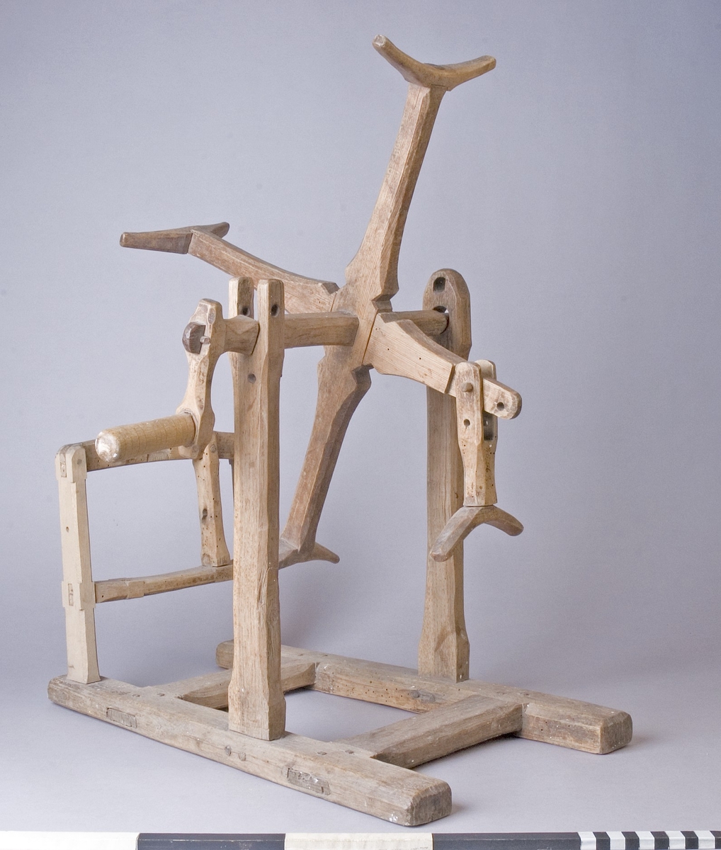 Härvel av furu, ek och björk. Bottenplatta av H-formad ram med två ståndare som bär upp härvelhjulet och två ståndare för hållare till garnspole. Härvelhjulet med fyra armar, varav ett är ledat. Hjulets axel med svarvad vev. Tappad med träplugg.