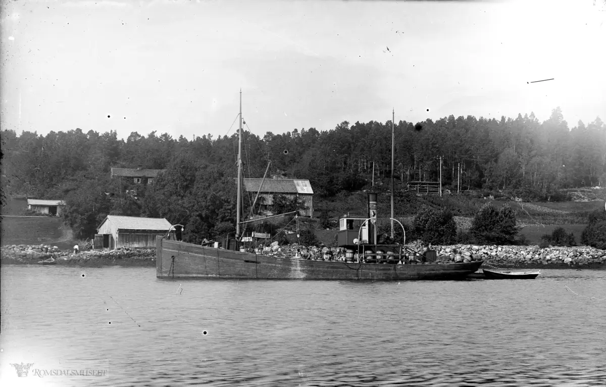 Lastebåt med tønner inne på Dragvågen for å kjøpe og salte sild.