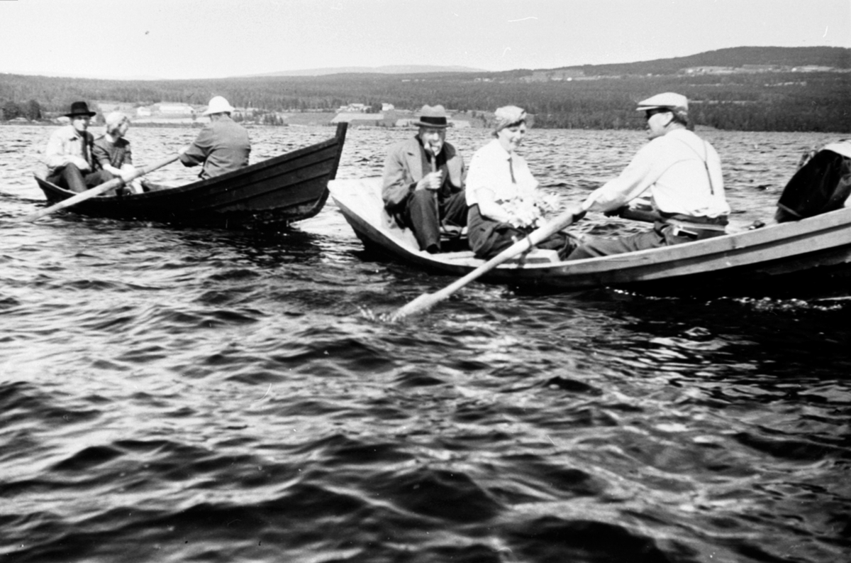 Familien Hauger og kunstneren Johan Nordhagen (1856-1956) i robåter på Næra i Ringsaker.