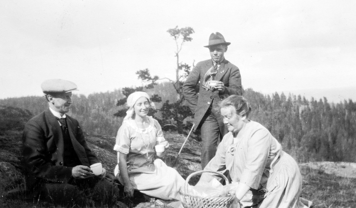 Utflukt til Gjellberget, Tangen. F. v Ingvald Lundby, Anna Furuseth, Gunnar Lundby og Hilda Nikoline Lundby, ca. 1925. Nistekurv, måltid. 