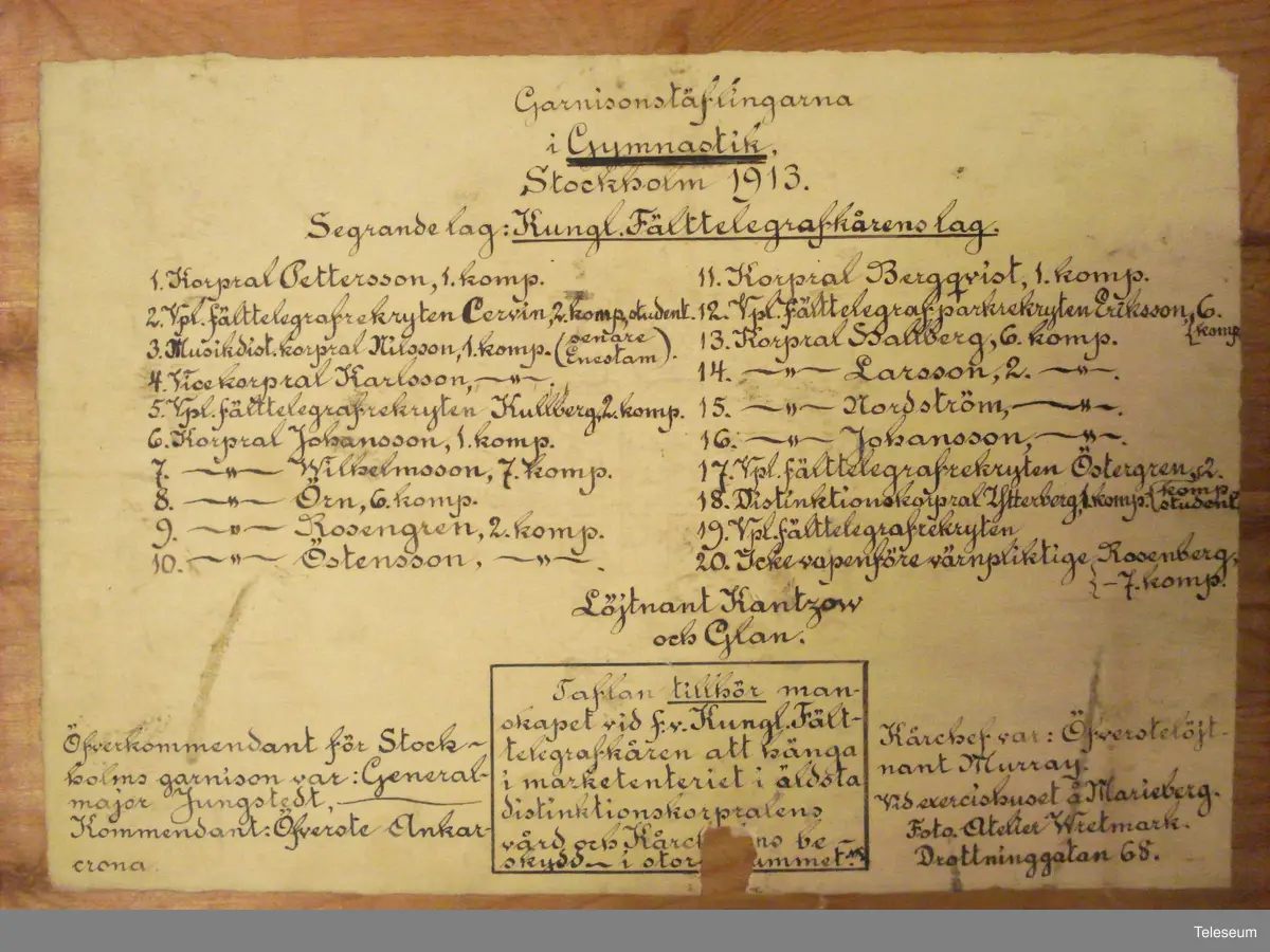 Segrande lag i Garnisonstävlingarna i gymnastik i Stockholm 1913. Kungliga Fälttelegrafkårens lag. Ofiiceren på fotot är Löjtnant Nils Gustav Kantzow med hunden Glan.
Beskrivande text på baksidan, med bl. a. namnen på truppens deltagare.
