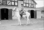 Livhusar i uniform m/1910 och mössa m/1895 på tilldelad stamhäst på K 3 kaserngård söder om skvadronstallet