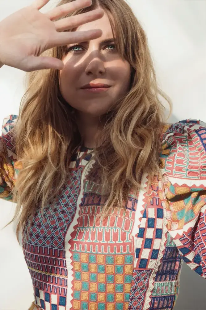 Artistfoto av Ingebjørg Bratland som skuggar for sola med handa