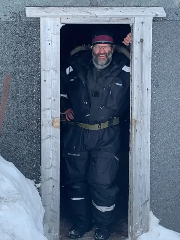 Eystein Markusson, direktør for Svalbard Museum, smilende i døråpningen.