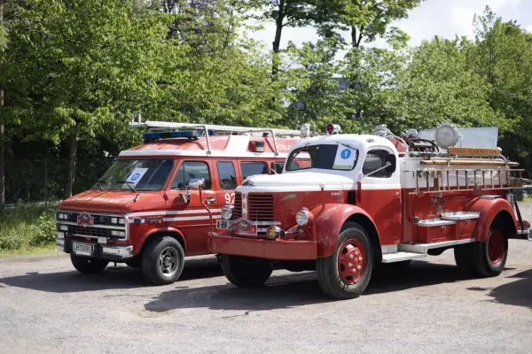 Two red vintage fire trucks on display at Norsk Folkemuseum during the 2025 Amcar and Fire Truck Weekend.