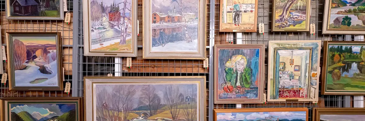 En gallervägg med flera olika tavlor i ramar. 