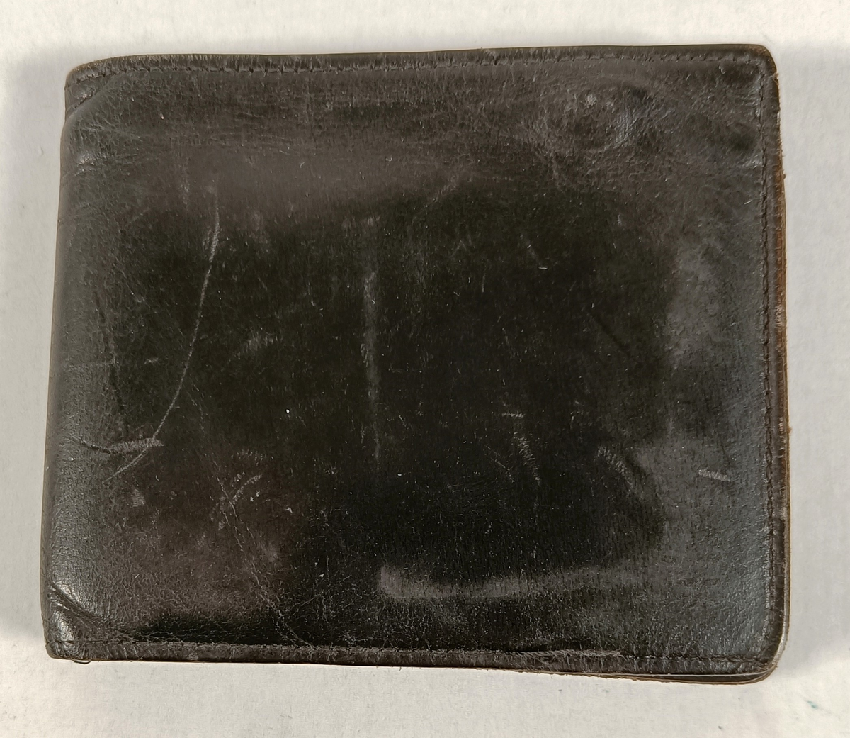 Lommebok i skinn som inneholder Indiske sedler og mynter, Canadiske mynter og Identifikasjonskort for Alf Oskar Johansen.