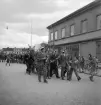 Studentfinal, 1944. 
En student körs iväg i lövad  kärra längs Storgatan, av sina kamrater. I bakgrunden syns P.N. Perssons fastighet. 

Angående avgångsklassen 1944 - se 