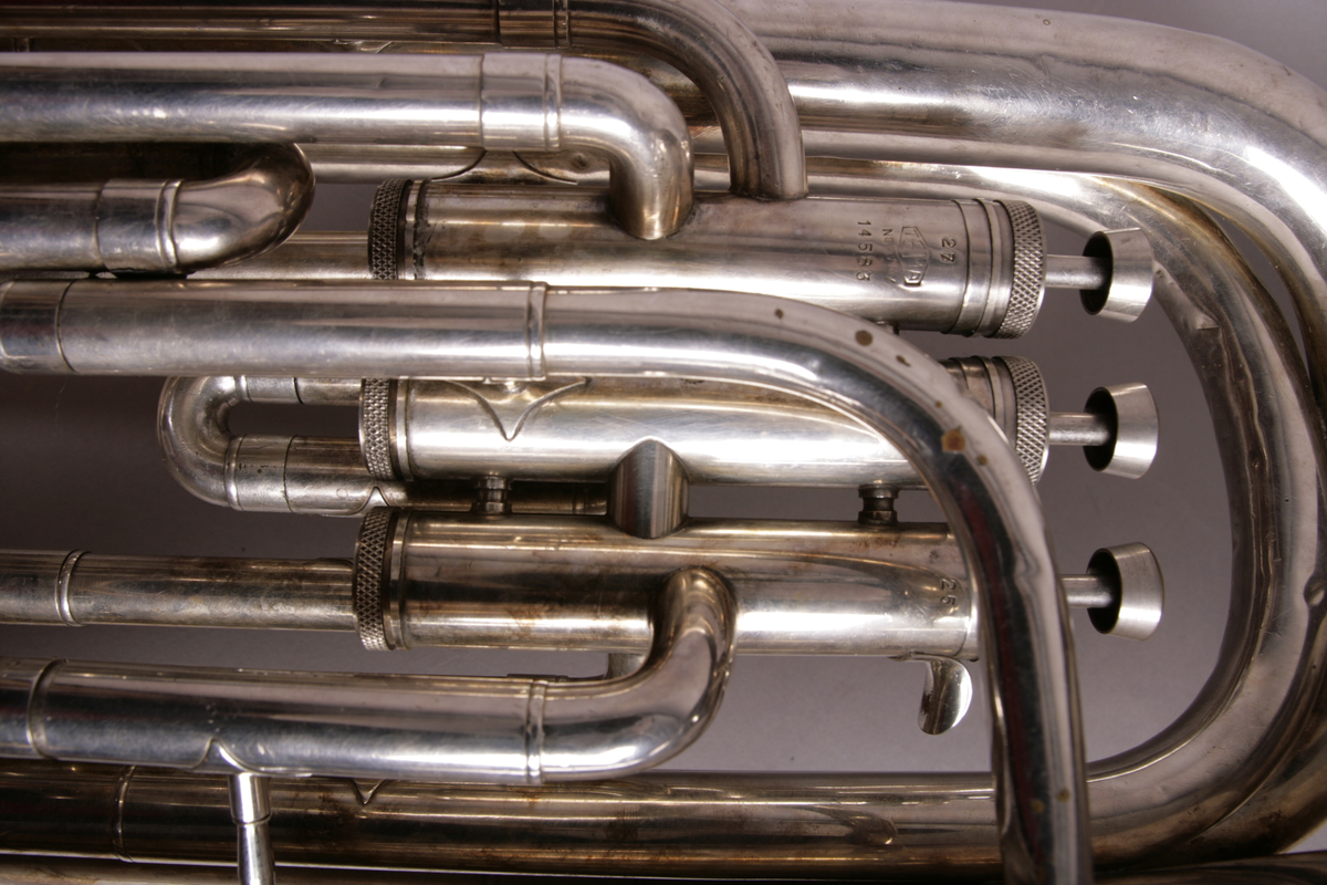 Blåseinstrument i metall med klaffer og ventiler.
