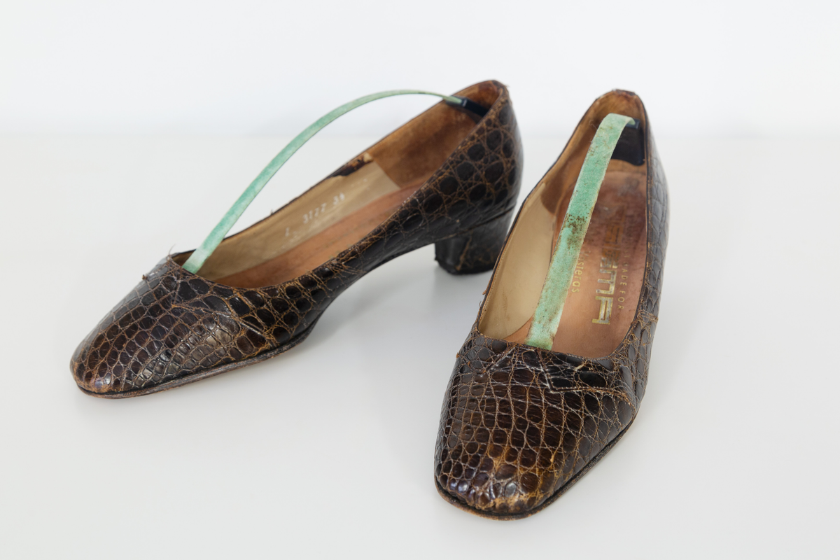 Pumps i brunt reptilskin. Storlek 3 1/2. På skons insida finns texten "Especially made for SIGMA sko Västerås". 
