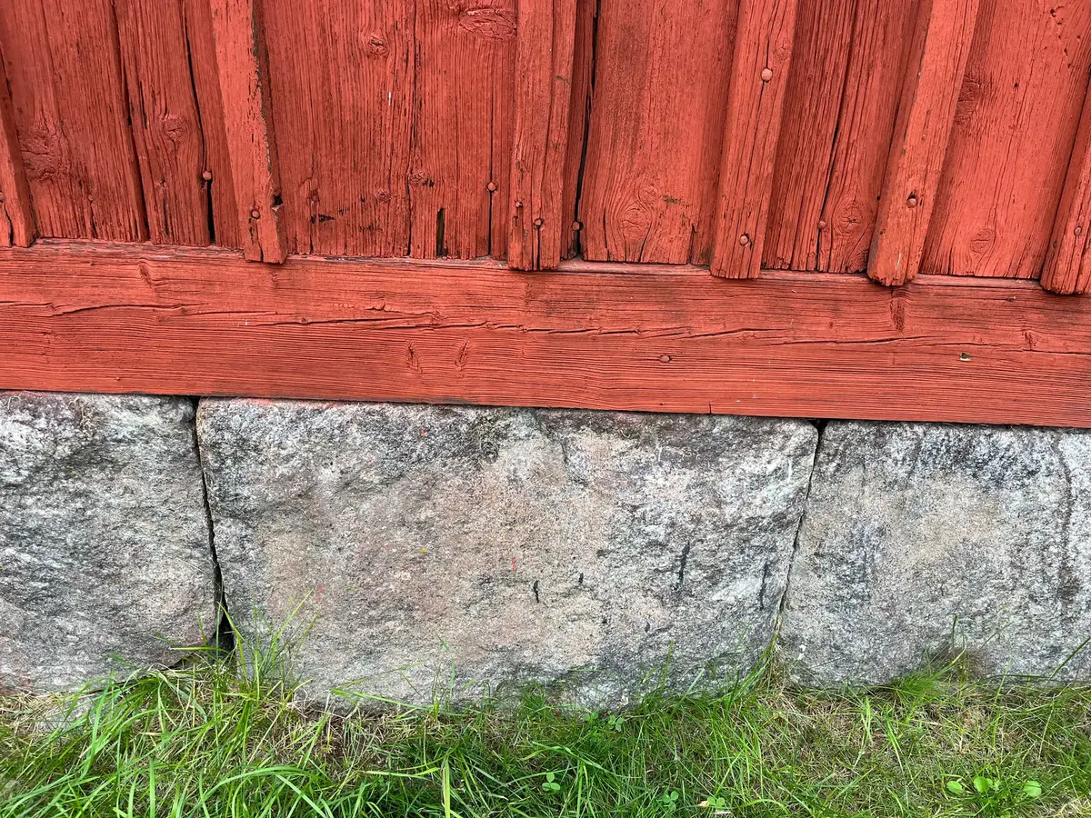 Gammal husgrund med faluröd vägg